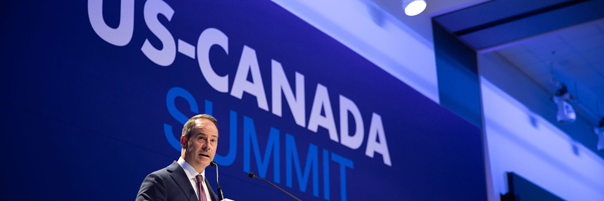 Darryl White speaking at a podium during the US-Canada Summit